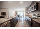 Open kitchen showcasing stainless steel appliances, granite countertops, and a dining area at 6913 Evening Orchid St, North Las Vegas, NV 89086
