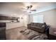 Cozy living room with a view of the kitchen, featuring a comfortable sofa and ceiling fan at 6913 Evening Orchid St, North Las Vegas, NV 89086