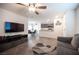 Open-concept living space with a view of the dining area and kitchen, with stylish laminate flooring at 6913 Evening Orchid St, North Las Vegas, NV 89086