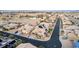An elevated street view of a home featuring solar panels, desert landscaping, and circular driveway at 7682 Rafter Ct, Las Vegas, NV 89139