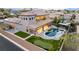 Expansive home featuring a backyard pool with waterfall, putting green, covered patio, and desert landscaping at 7682 Rafter Ct, Las Vegas, NV 89139