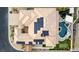 Aerial view of a solar panel-equipped home with a backyard featuring a unique pool, patio and a putting green at 7682 Rafter Ct, Las Vegas, NV 89139