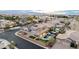 An elevated view of a home with a backyard oasis including a custom pool, patio and putting green at 7682 Rafter Ct, Las Vegas, NV 89139
