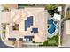Aerial view of the home with a solar panel roof and backyard with a pool, patio, and putting green at 7682 Rafter Ct, Las Vegas, NV 89139