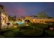 Backyard features a putting green, swimming pool, cascading waterfall, and manicured landscaping at 7682 Rafter Ct, Las Vegas, NV 89139