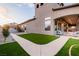 Well-manicured backyard showcasing an expansive patio, lush lawn, and inviting outdoor seating, perfect for relaxation and entertaining at 7682 Rafter Ct, Las Vegas, NV 89139