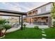 Expansive backyard featuring a built-in bar, outdoor seating, and a sparkling pool with a captivating waterfall feature at 7682 Rafter Ct, Las Vegas, NV 89139