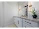 Elegant bathroom boasts marble countertops, white cabinetry, and brushed gold hardware accents at 7682 Rafter Ct, Las Vegas, NV 89139