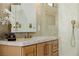 Modern bathroom boasts a marble countertop, stylish wood cabinets, and a sleek gold faucet at 7682 Rafter Ct, Las Vegas, NV 89139