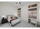 Bright bedroom with neutral tones, a comfortable bed, and large windows offering scenic views at 7682 Rafter Ct, Las Vegas, NV 89139