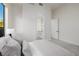 Comfortable bedroom showcasing a serene view of its ensuite bathroom and minimalist decor at 7682 Rafter Ct, Las Vegas, NV 89139