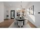 Dining room featuring a modern chandelier, stylish chairs and artwork at 7682 Rafter Ct, Las Vegas, NV 89139