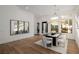 Elegant dining room with black table, white chairs, and decorative wall mirrors at 7682 Rafter Ct, Las Vegas, NV 89139