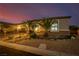 Elegant exterior featuring desert landscaping, warm lighting, and a well-maintained yard for enhanced curb appeal at 7682 Rafter Ct, Las Vegas, NV 89139