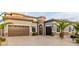Elegant exterior featuring desert landscaping, warm lighting, and a well-maintained yard for enhanced curb appeal at 7682 Rafter Ct, Las Vegas, NV 89139