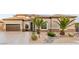 Well-maintained home exterior with desert landscaping, two-car garage, and front yard at 7682 Rafter Ct, Las Vegas, NV 89139