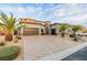 Charming exterior features desert landscaping, warm lighting, and lovely architectural details that enhance the home's facade at 7682 Rafter Ct, Las Vegas, NV 89139