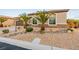 Charming single-story home with desert landscaping, palm trees, and stacked stone accents at 7682 Rafter Ct, Las Vegas, NV 89139