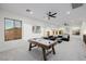 Spacious game room with air hockey table, comfortable seating, and lots of natural light at 7682 Rafter Ct, Las Vegas, NV 89139
