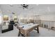 Open game room features comfortable seating, air hockey, and overlooks the living spaces below at 7682 Rafter Ct, Las Vegas, NV 89139