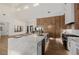 Open kitchen with large island, stainless steel appliances, and hardwood flooring at 7682 Rafter Ct, Las Vegas, NV 89139