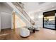 Bright space with a modern staircase, statement onyx wall, and views of the outdoor pool at 7682 Rafter Ct, Las Vegas, NV 89139
