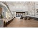Expansive living area with bar seating, marble accent wall, and stylish furniture at 7682 Rafter Ct, Las Vegas, NV 89139