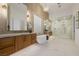 Well lit main bathroom features dual vanities, soaking tub, and large glass shower at 7682 Rafter Ct, Las Vegas, NV 89139