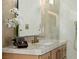 Bathroom features a modern vanity with light wood cabinets and gold fixtures at 7682 Rafter Ct, Las Vegas, NV 89139