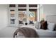 Bright main bedroom features sitting area, soft carpet, and views of the backyard at 7682 Rafter Ct, Las Vegas, NV 89139