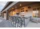 Covered outdoor bar with countertop seating, perfect for entertaining guests with easy access to the backyard at 7682 Rafter Ct, Las Vegas, NV 89139