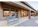Covered patio featuring stone pillars, outdoor seating area, and views of the beautiful backyard at 7682 Rafter Ct, Las Vegas, NV 89139