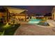 Stunning pool with waterfall feature, spa, and covered patio area offers luxury outdoor living at 7682 Rafter Ct, Las Vegas, NV 89139