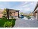 Inviting backyard oasis featuring a refreshing pool with a waterfall and a cozy covered patio with comfortable seating at 7682 Rafter Ct, Las Vegas, NV 89139