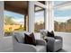 Sitting area features comfortable chairs, plush pillows, and view of the backyard at 7682 Rafter Ct, Las Vegas, NV 89139