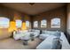 Bright sitting room with comfortable couches and open windows showing lovely neighborhood views at 7682 Rafter Ct, Las Vegas, NV 89139