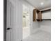 Walk-in closet with custom wood shelving adjacent to a sleek, modern bathroom with a glass-enclosed shower at 7682 Rafter Ct, Las Vegas, NV 89139