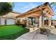 Backyard patio with putting green, covered dining area, and serene outdoor living space at 8455 Stange Ave, Las Vegas, NV 89129