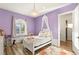 Charming bedroom features a decorative chandelier, canopy bed, and natural light from the arched window at 8455 Stange Ave, Las Vegas, NV 89129