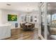 Elegant dining room with a modern chandelier, large windows, and stylish decor at 8455 Stange Ave, Las Vegas, NV 89129