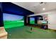 Golf simulator room with a large screen, putting green, and comfortable seating area at 8455 Stange Ave, Las Vegas, NV 89129