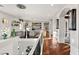 Second-floor hallway with a view of a bright living room, hardwood flooring, and a chandelier at 8455 Stange Ave, Las Vegas, NV 89129