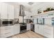 Well-lit kitchen featuring stainless steel appliances, white cabinetry, and stylish backsplash, offering modern convenience at 8455 Stange Ave, Las Vegas, NV 89129