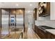 Gourmet kitchen featuring high-end stainless steel appliances, wood cabinets, and a large center island with sink at 8455 Stange Ave, Las Vegas, NV 89129
