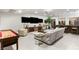 Open living room with bar, game table, large sectional couch, and multiple flatscreen TVs at 8455 Stange Ave, Las Vegas, NV 89129