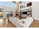 Bright living room with soaring ceilings, a stone fireplace, and a large comfortable sectional sofa at 8455 Stange Ave, Las Vegas, NV 89129