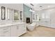 Luxurious main bathroom with a freestanding tub, dual vanities, and modern fixtures, perfect for relaxation at 8455 Stange Ave, Las Vegas, NV 89129