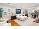 Spacious main bedroom with natural light, neutral colors, and hardwood floors offering a relaxing retreat at 8455 Stange Ave, Las Vegas, NV 89129