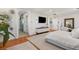 Bright main bedroom featuring hardwood floors, a TV, and an open layout for comfort at 8455 Stange Ave, Las Vegas, NV 89129