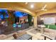 Covered patio features comfortable seating next to the pool and landscaped yard at 8455 Stange Ave, Las Vegas, NV 89129